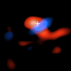ALMA image of the cool gas within the accretion disk. Areas in blue are moving toward us, while the regions in red are moving away—evidence that the accretion disk is spinning around the black hole, which is shown by the crosshair.